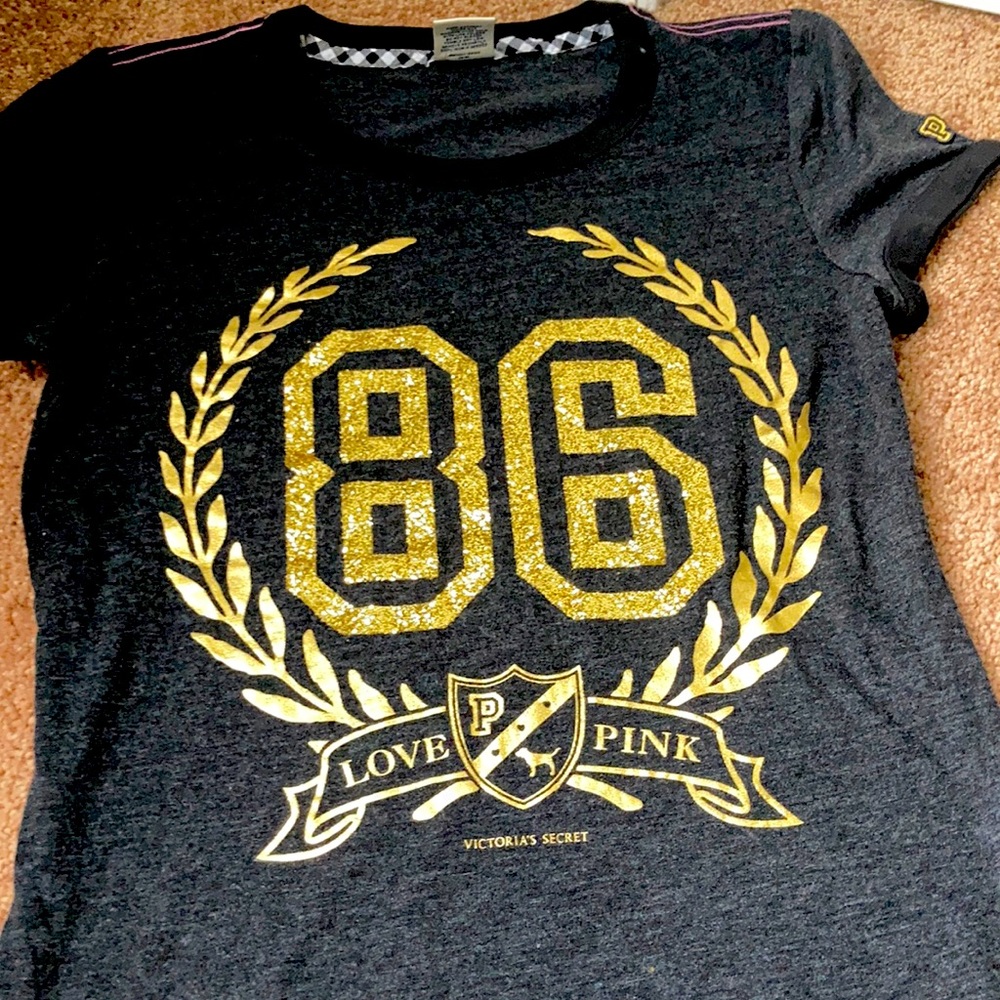 It a shirt that’s says pink on it for from Victoria Secret is a gray  gold shirt